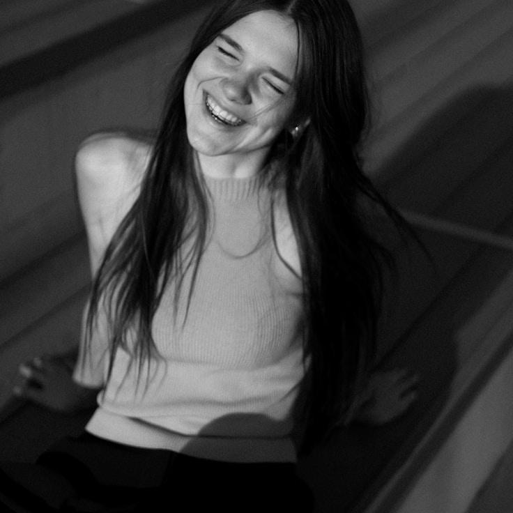 Avery Singh, Lead Design Curator at MeadowCrestBundle, reviewing corporate floral arrangements